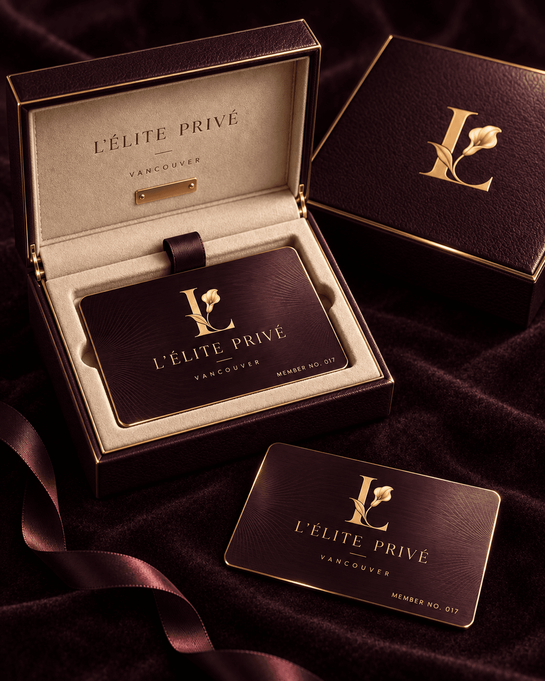 L’Élite Privé aubergine membership cards with gold detailing, nestled in an ivory-lined presentation case